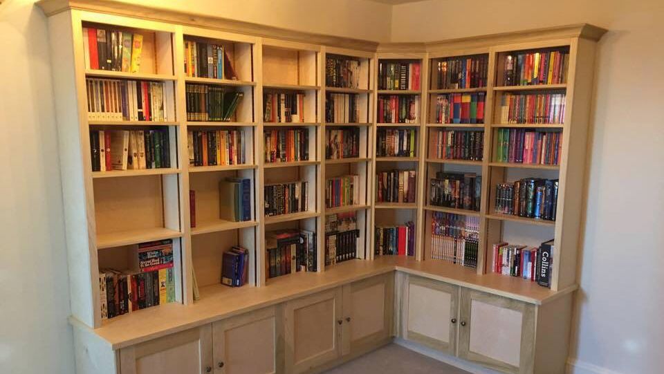 Wall to wall corner bookcase with cupboards below
