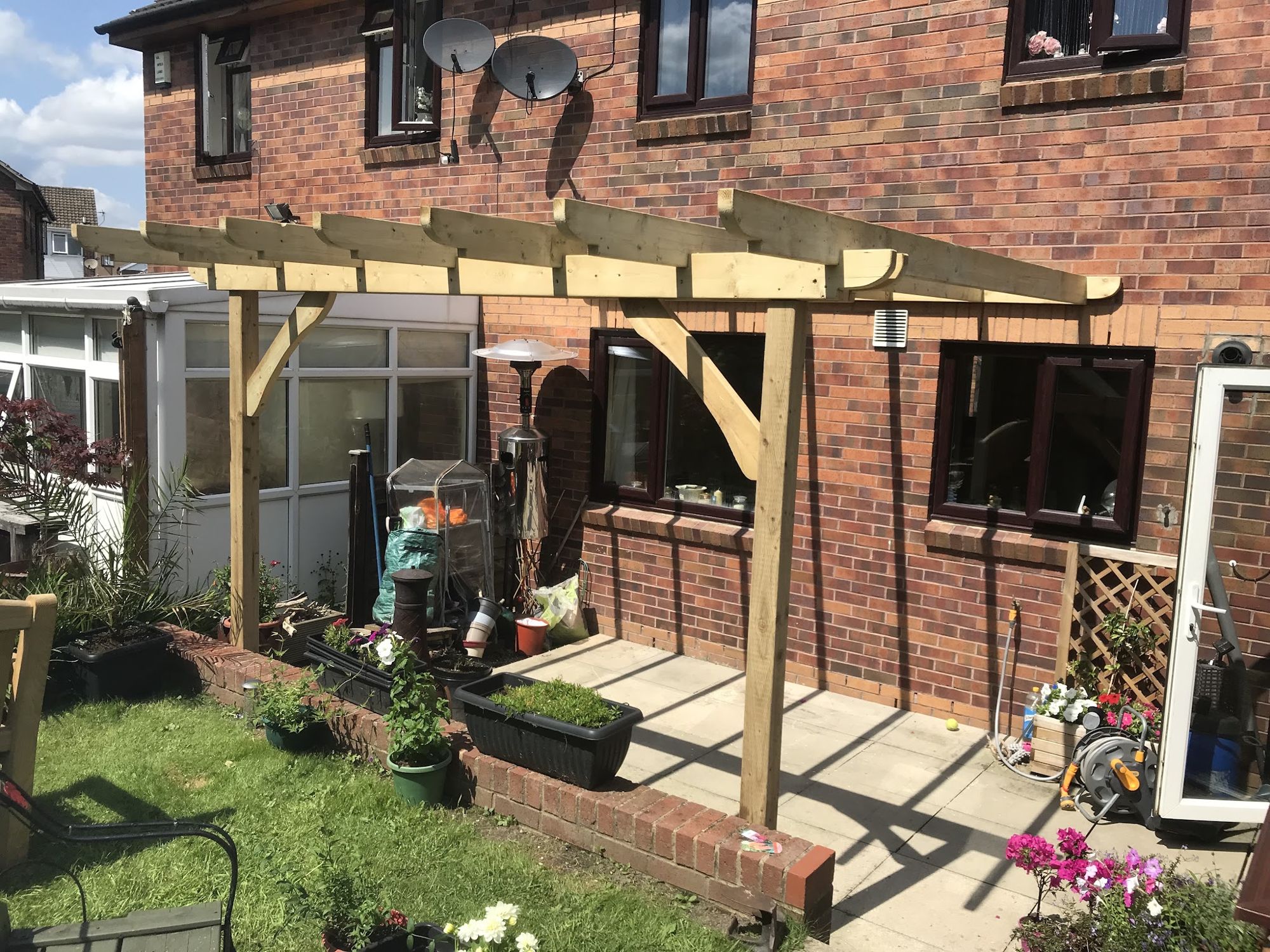 Timber lean-to pergola over a garden patio