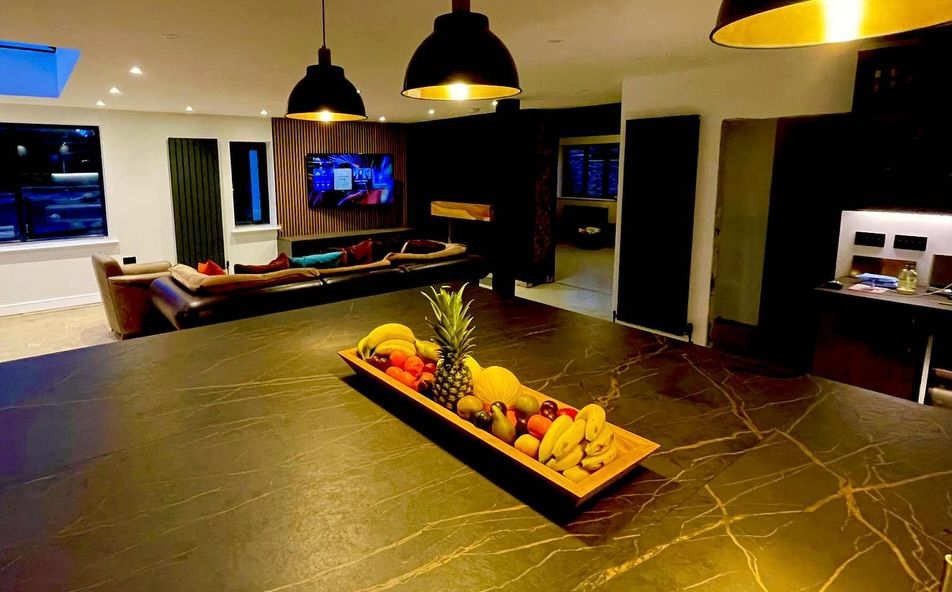 Open plan kitchen and living space with a slatted media wall